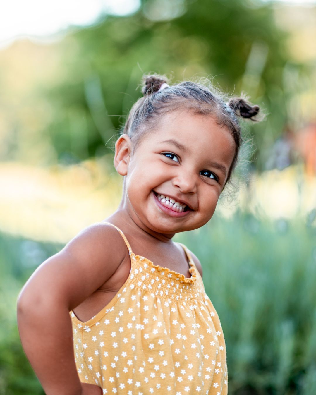 a girl smiling with pigtails